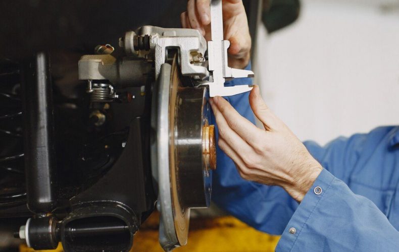 mechanic-with-tool-wheel-hands-mechanic-blue-work-clothes_1157-46153
